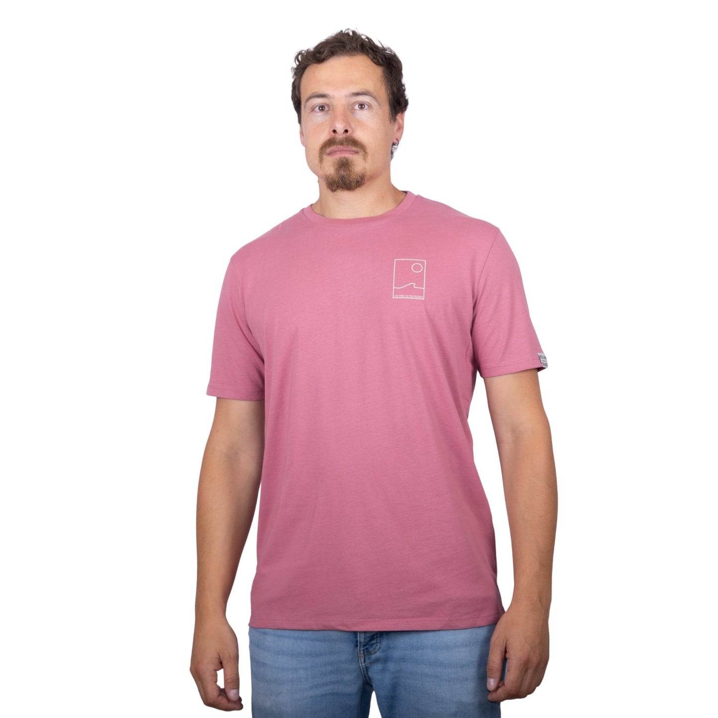 Tee-shirt unisexe rose foncé en coton biologique avec petit encadré vague / soleil minimaliste et écriture "free as ocean" beige sur la poitrine, vu de face sur mannequin homme